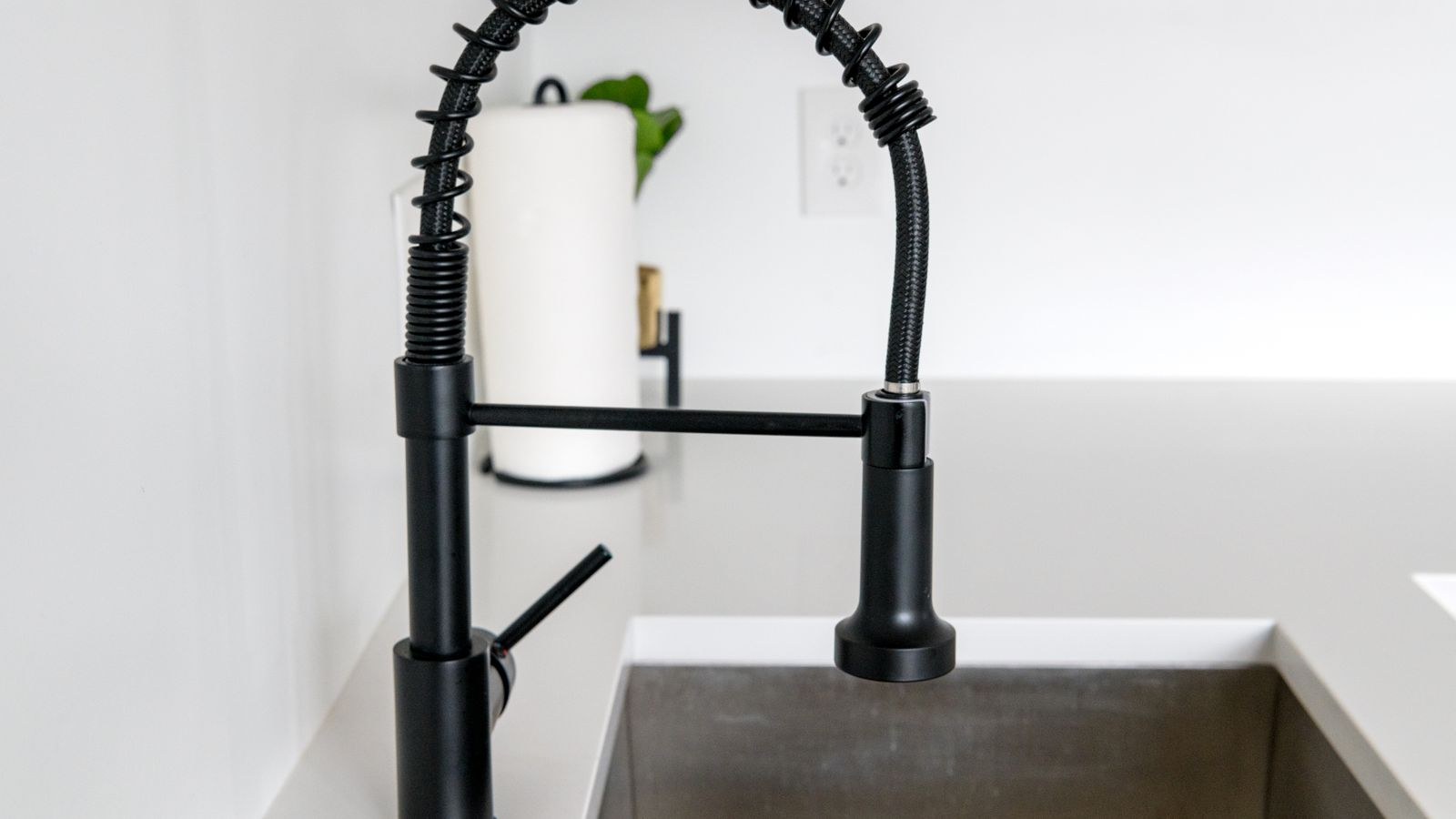 Black kitchen faucet on a white deck