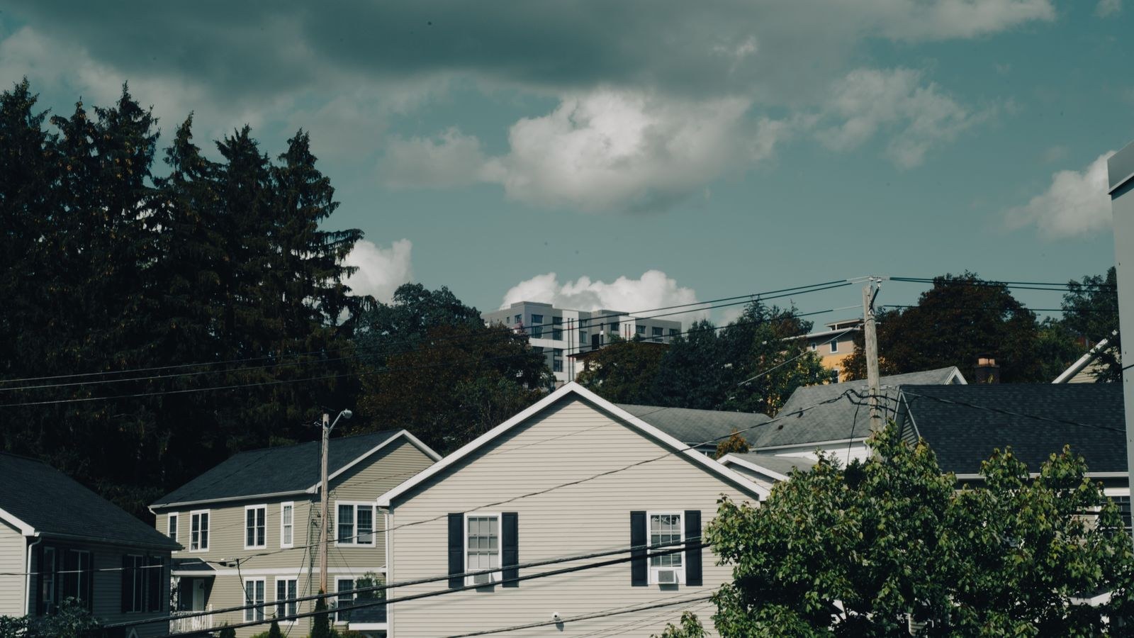 Quiet suburban houses under a cloudy sky
